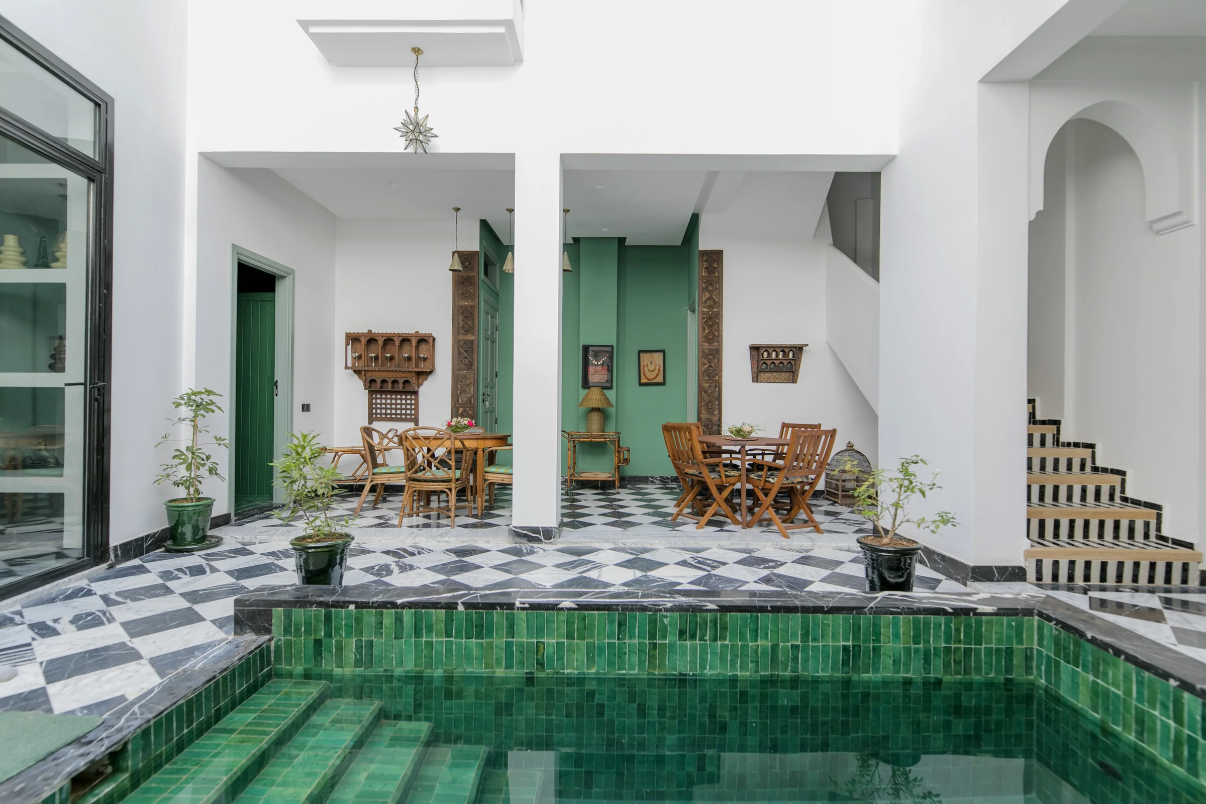 The sunlit patio and green pool at Palazzo Montefiore